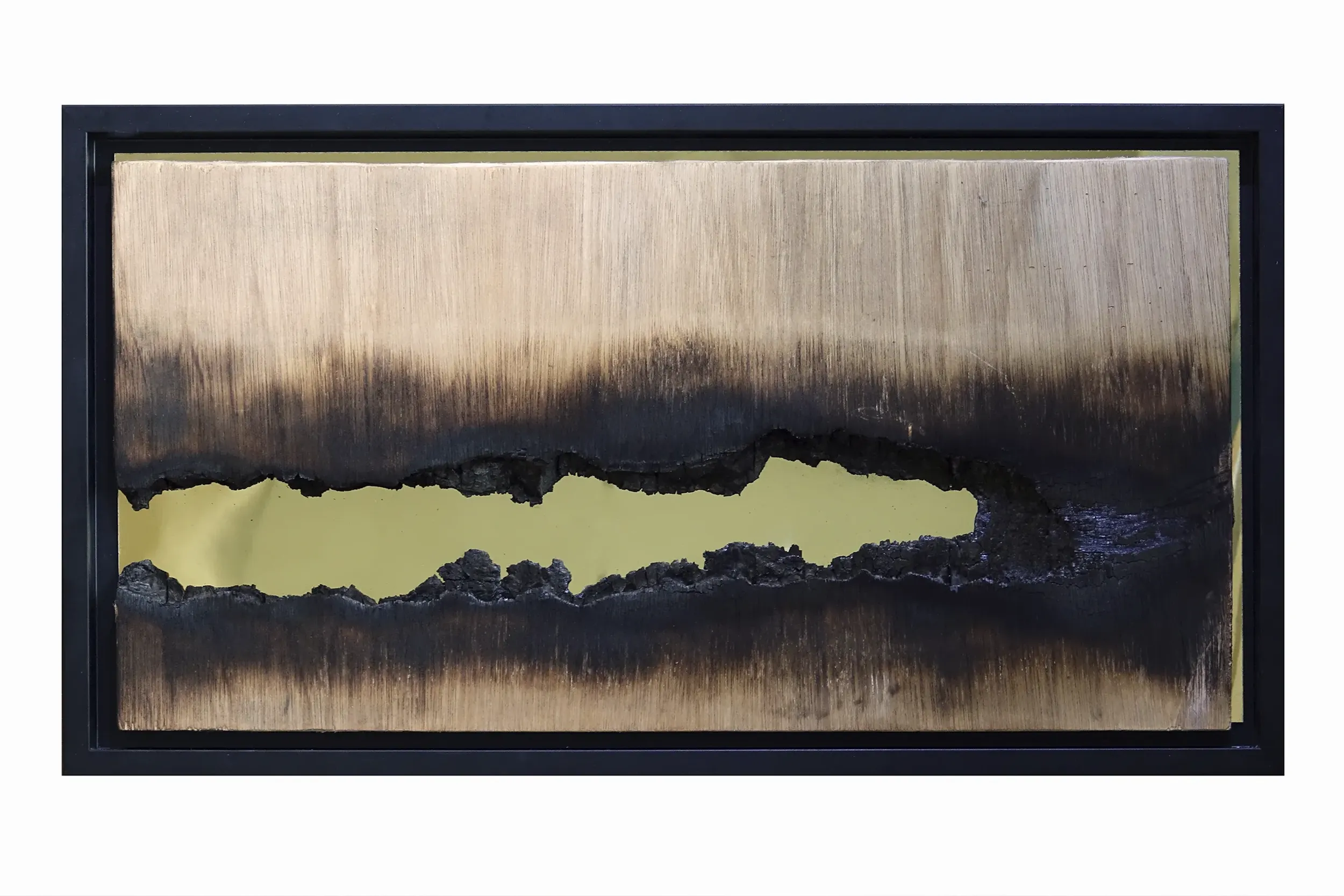 A close up view of the Fire Painting 'Seeing you the first time, again' by artist Damian Boylan. Showing the carbonised wood surface along with the golden mirrored poly(methyl methacrylate) substrate.